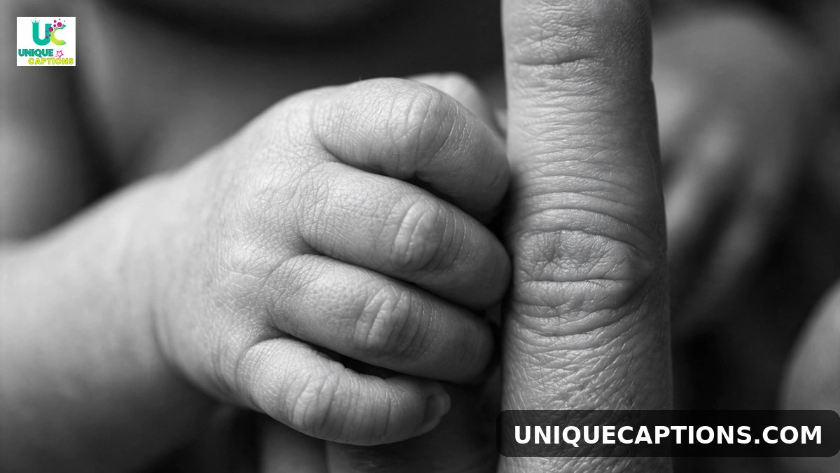 Heartfelt 11 month baby caption close-up of a tiny baby hand holding a parent's finger
