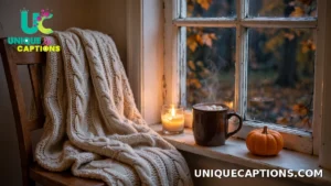 Cozy blanket, mug of cocoa and a small pumpkin by a window on a fall evening