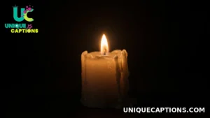 A single candle flame glowing softly in the darkness in quiet remembrance on Day of the Dead