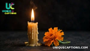 Single lit candle beside one bright orange marigold flower