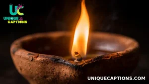 Single diya flame in a macro close-up against a dark background