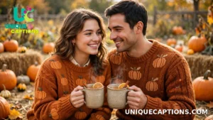 Couple in pumpkin sweaters holding mugs of cider together