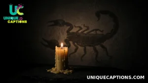 A single lit candle glowing in darkness with a faint scorpion silhouette motif